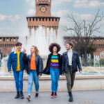 Group of friends tourist walking together outdoors in the city d